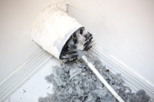 Brush and auger cleaning lint from dryer vent